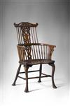 An extremely rare 18th century comb-back armchair.