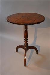 An early 19th century yew wood tripod table. An early 19th century yew wood tripod table.