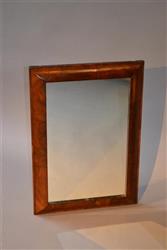 An early 18th century walnut cushion frame mirror. An early 18th century walnut cushion frame mirror.