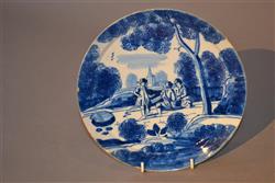 An early 18th century delft dished plate. An early 18th century delft dished plate.