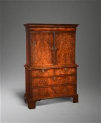 A small Queen Anne burr walnut cabinet on chest. A small Queen Anne burr walnut cabinet on chest.