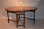 A Queen Anne yew wood gateleg table.