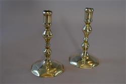 A pair of small Queen Anne brass candlesticks. A pair of small Queen Anne brass candlesticks.