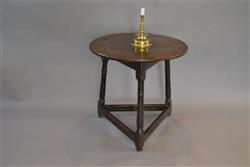 A Charles II oak cricket table. A Charles II oak cricket table.