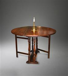 A William and Mary oak gateleg table. A William and Mary oak gateleg table.