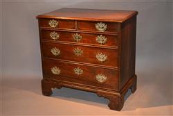 An elegant George II elm chest of drawers.