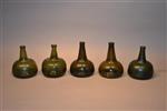 A collection of five 18th century wine bottles.